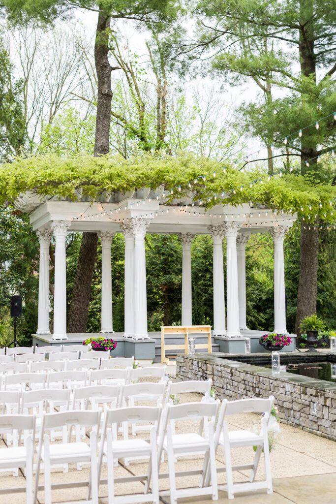 Outdoor Christian wedding ceremony on the Garden Terrace at Ceresville Mansion surrounded by lush greenery.
