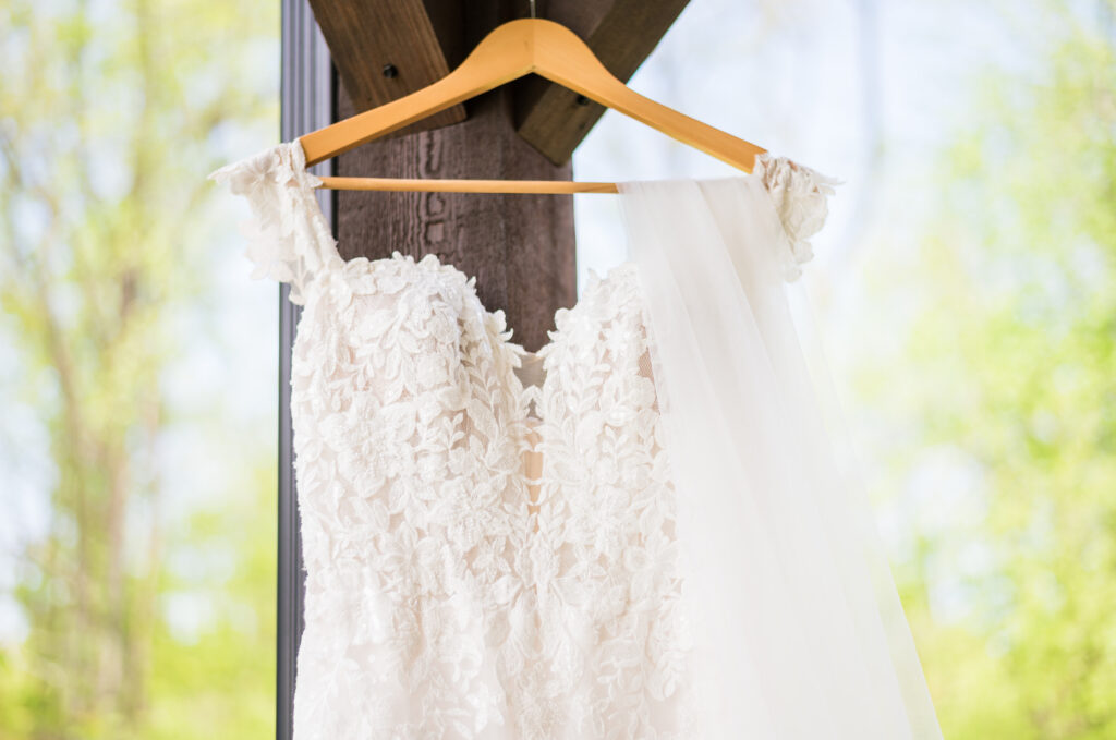 Romantic lace wedding dress detail captured in sunlight
