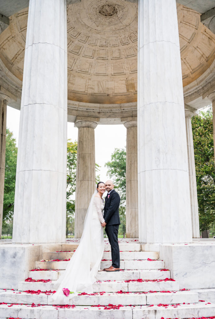 Bride and groom posing for portraits at the DC War Memorial in Washington, D.C.