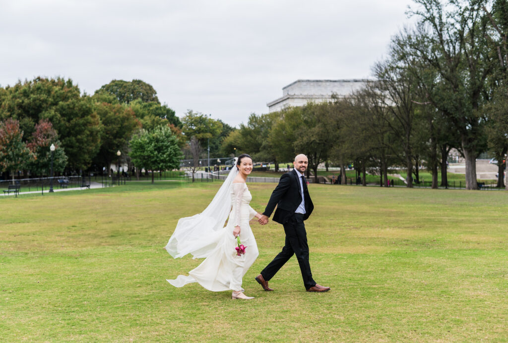 Couple taking portraits near the Lincoln Memorial during their DC wedding.