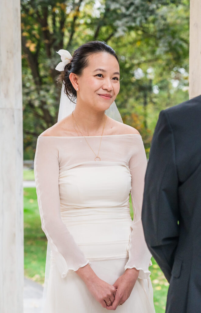 Bride smiling during wedding vows.