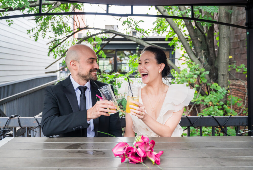 Bride and groom cheering with their drinks at Maketto in D.C.