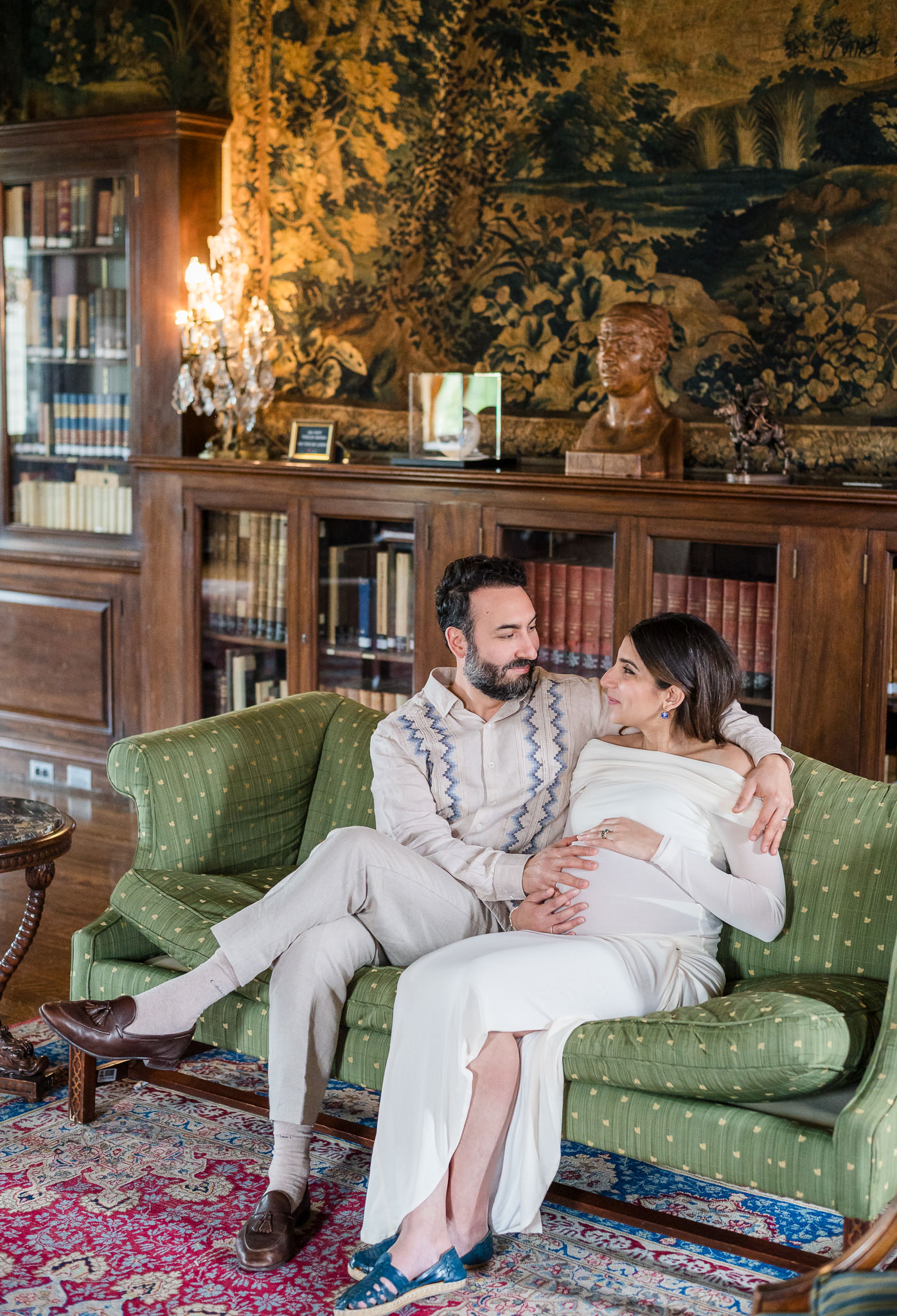Expecting parents smiling together in the historic library during their Washington, DC maternity session.