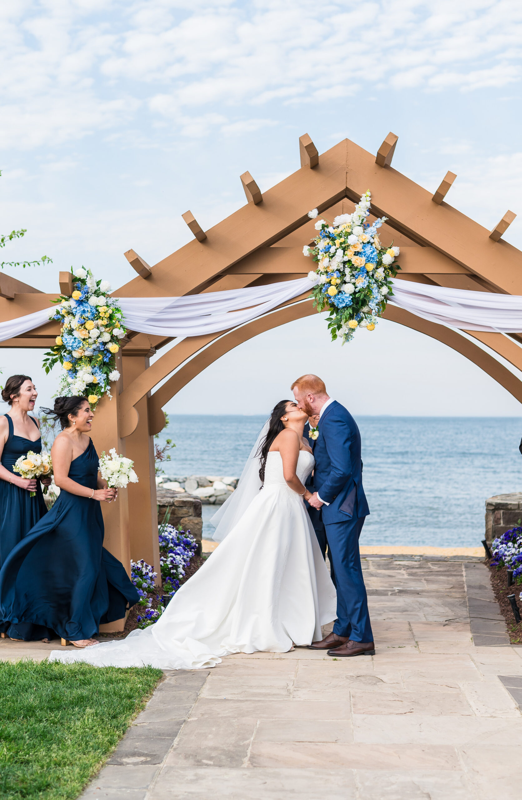 Couple kissing at ceremony overlooking the water at Herrington on the Bay