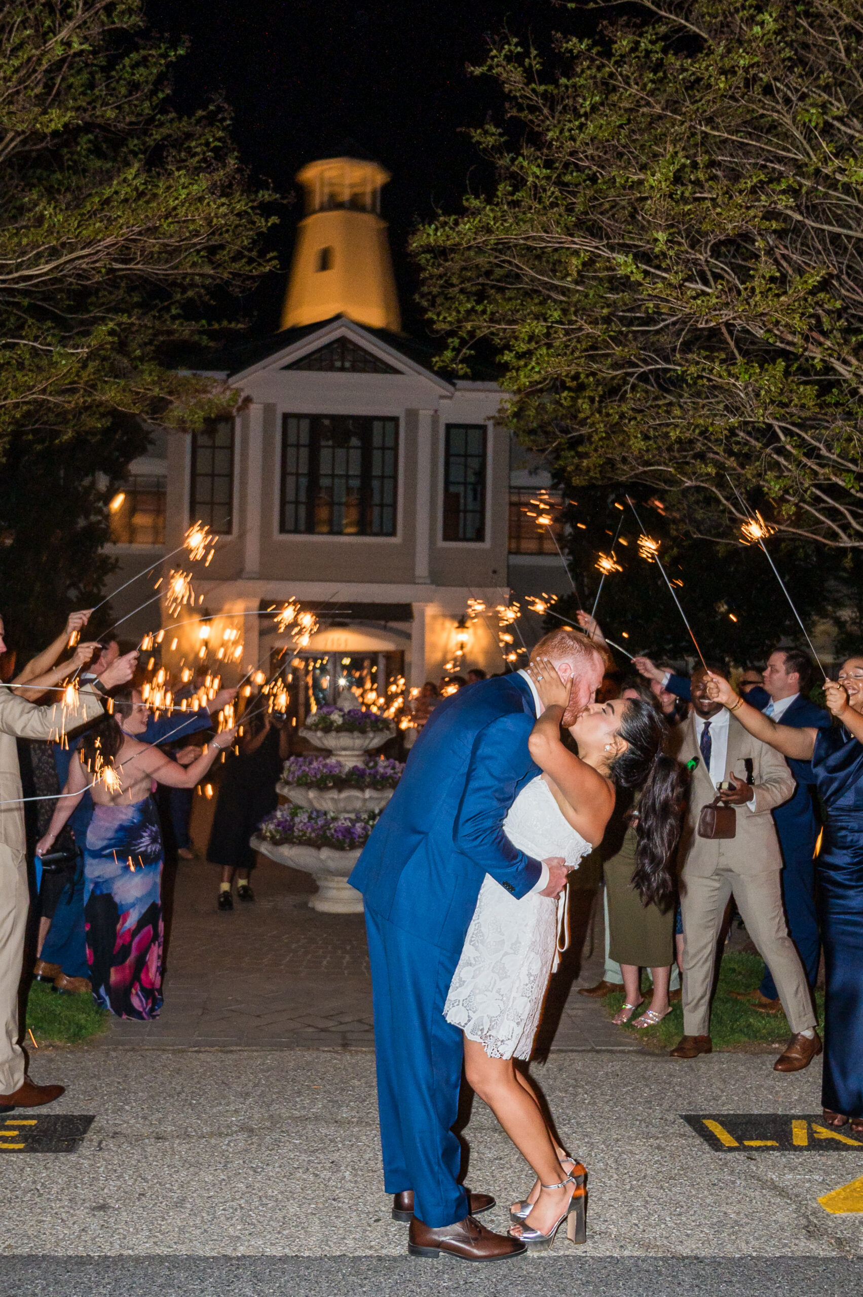 Wedding couple kissing at sparkler exit captured at Herrington on the Bay in North Beach Maryland