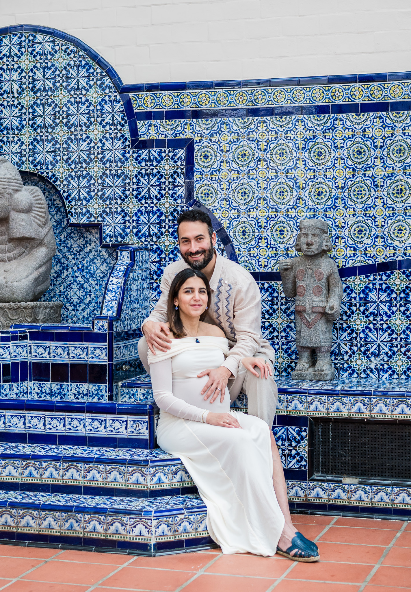 Expecting couple framed by the historic architecture of the Mexican Cultural Institute during their maternity session.